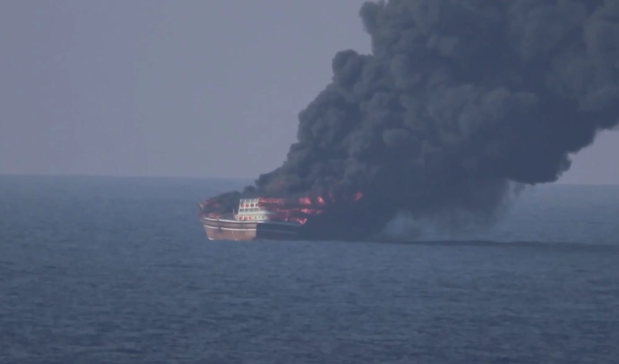 Dhow engulfed in flames in the Gulf of Oman, sending a massive plume of thick black smoke into the sky following a U.S. military strike on October 6, 2026.