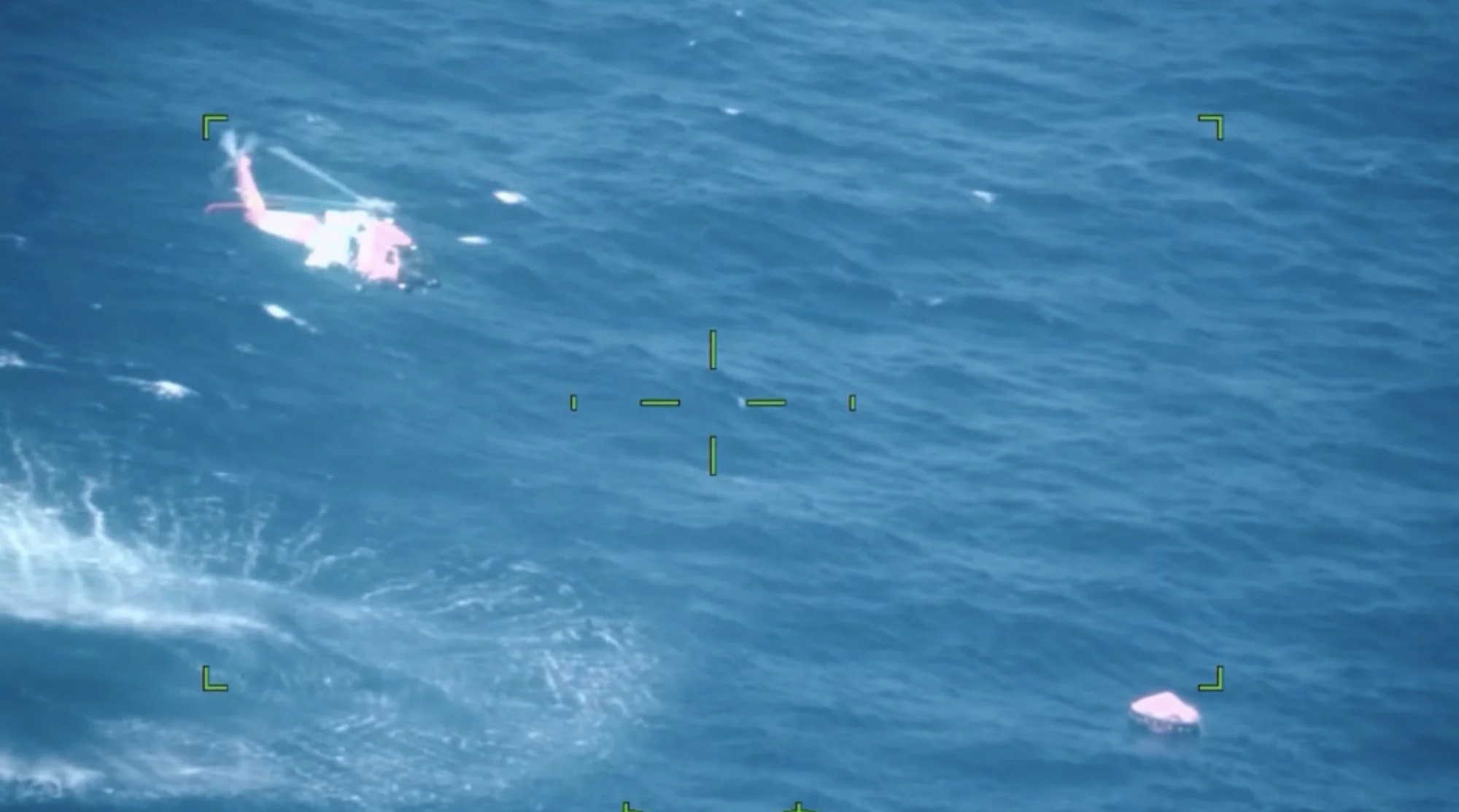 A U.S. Coast Guard Air Station New Orleans helicopter aircrew lowers a rescue swimmer to assist mariners aboard a life raft 100 miles south of Grand Isle, Louisiana, Oct. 12, 2026